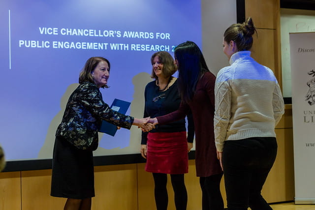 vice chancellor shaking hands with award winners